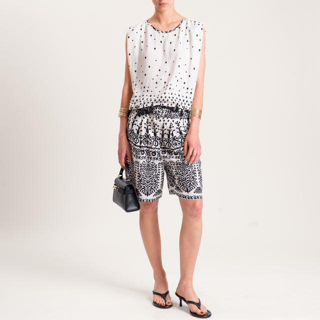 Tensione in-Blusa smanicata fantasia con nappine - burro/nero